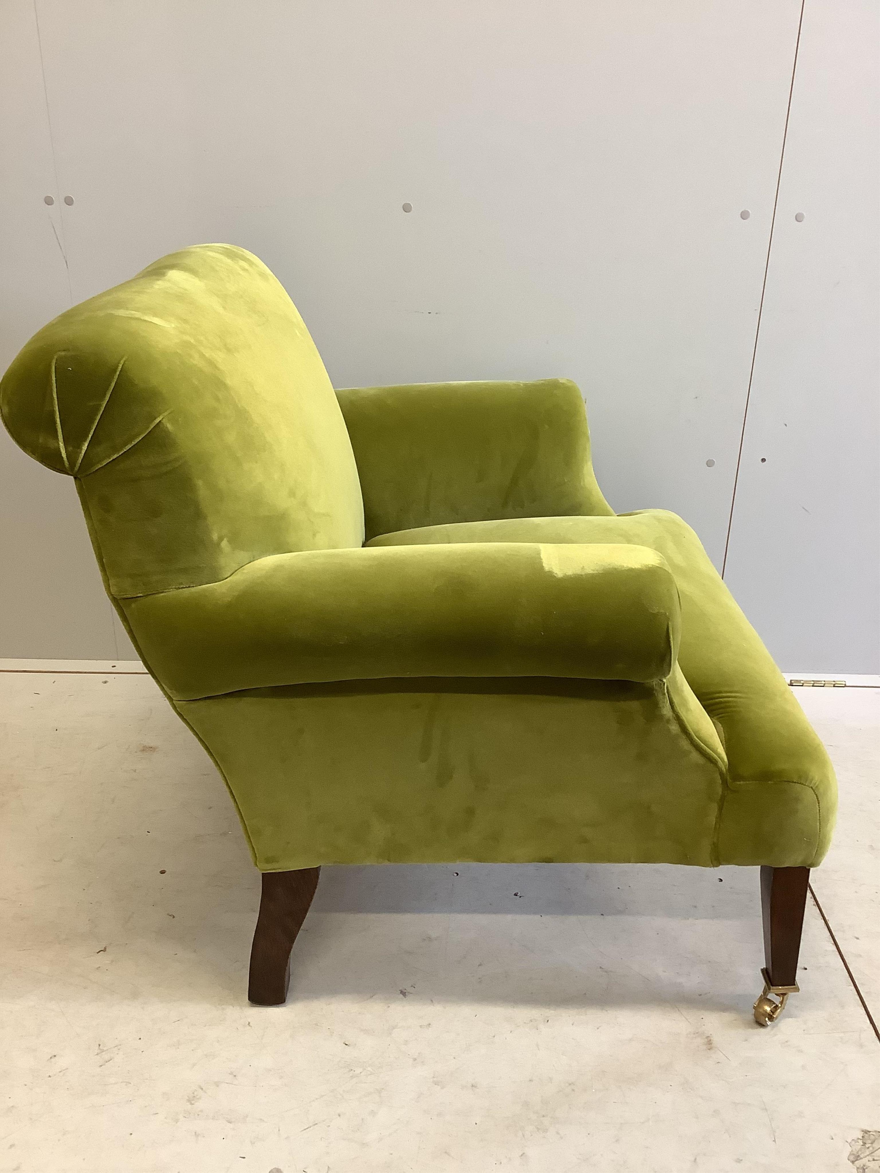 A Howard style green upholstered armchair, width 90cm, depth 80cm, height 84cm. Condition - fair to good